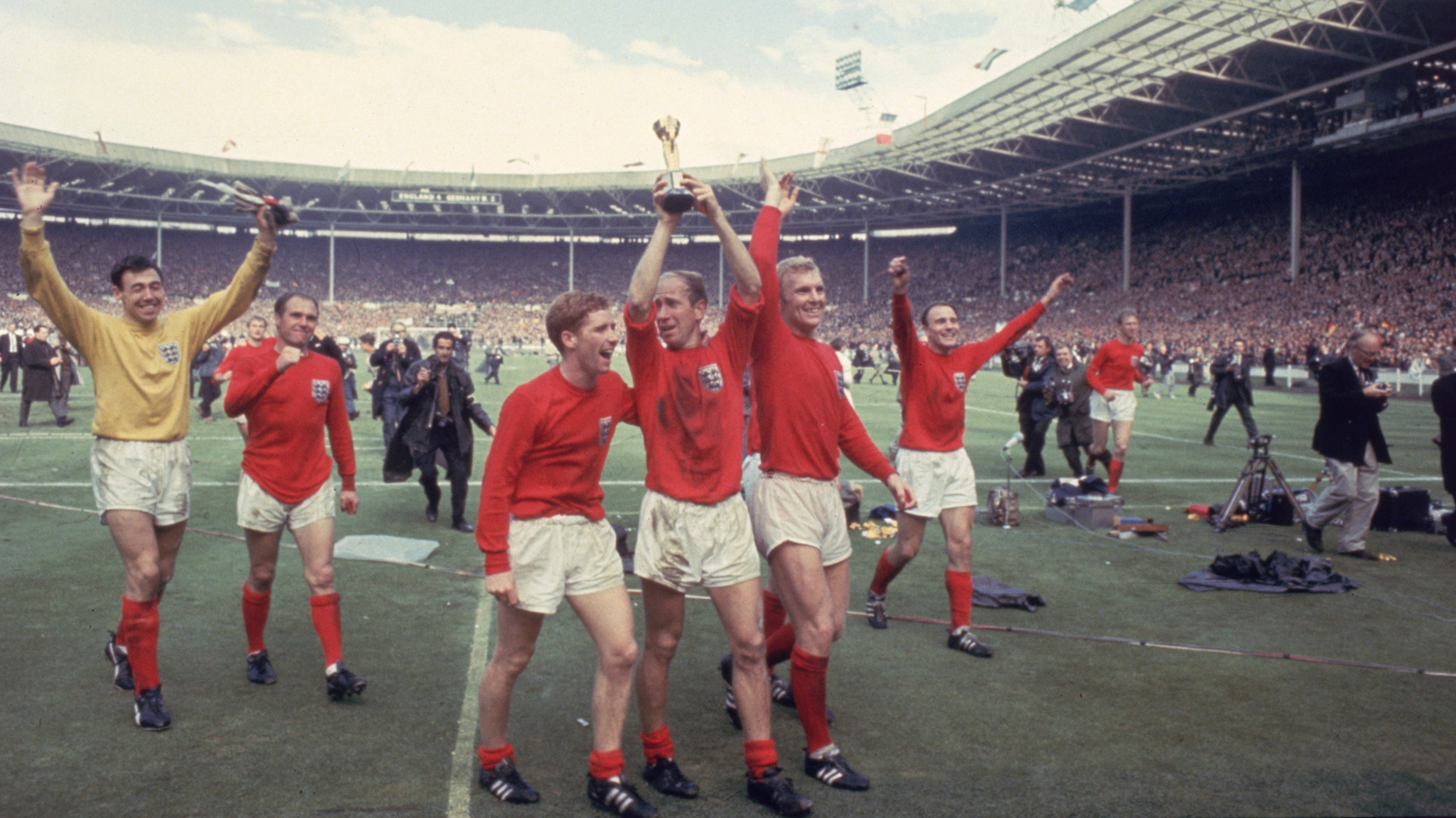 Bobby Charlton raises the Jules Rimet trophy in the air following England's 4-2 victory after extra time over West Germany in the World Cup Final at Wembley Stadium, 30th July 1966