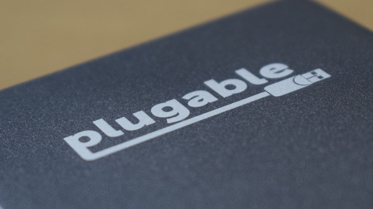 Close-up photo of the Plugable Thunderbolt 4 &amp; USB4 Quad Display Docking Station (TBT4-UDZ) showing the Plugable branding.
