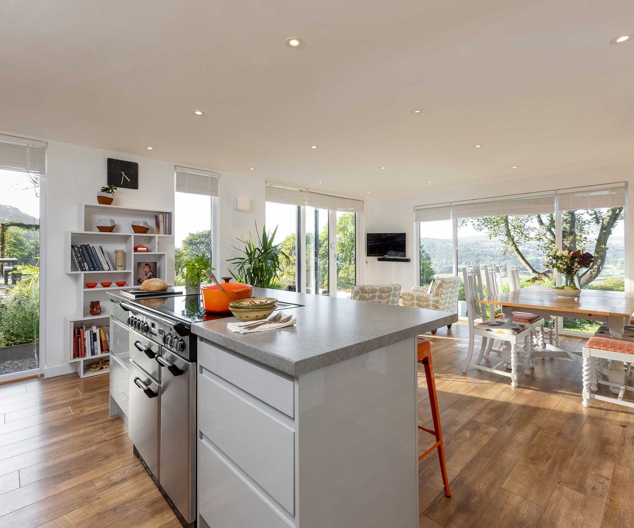 Modern kitchen extension with bifold doors, white units and grey worktops