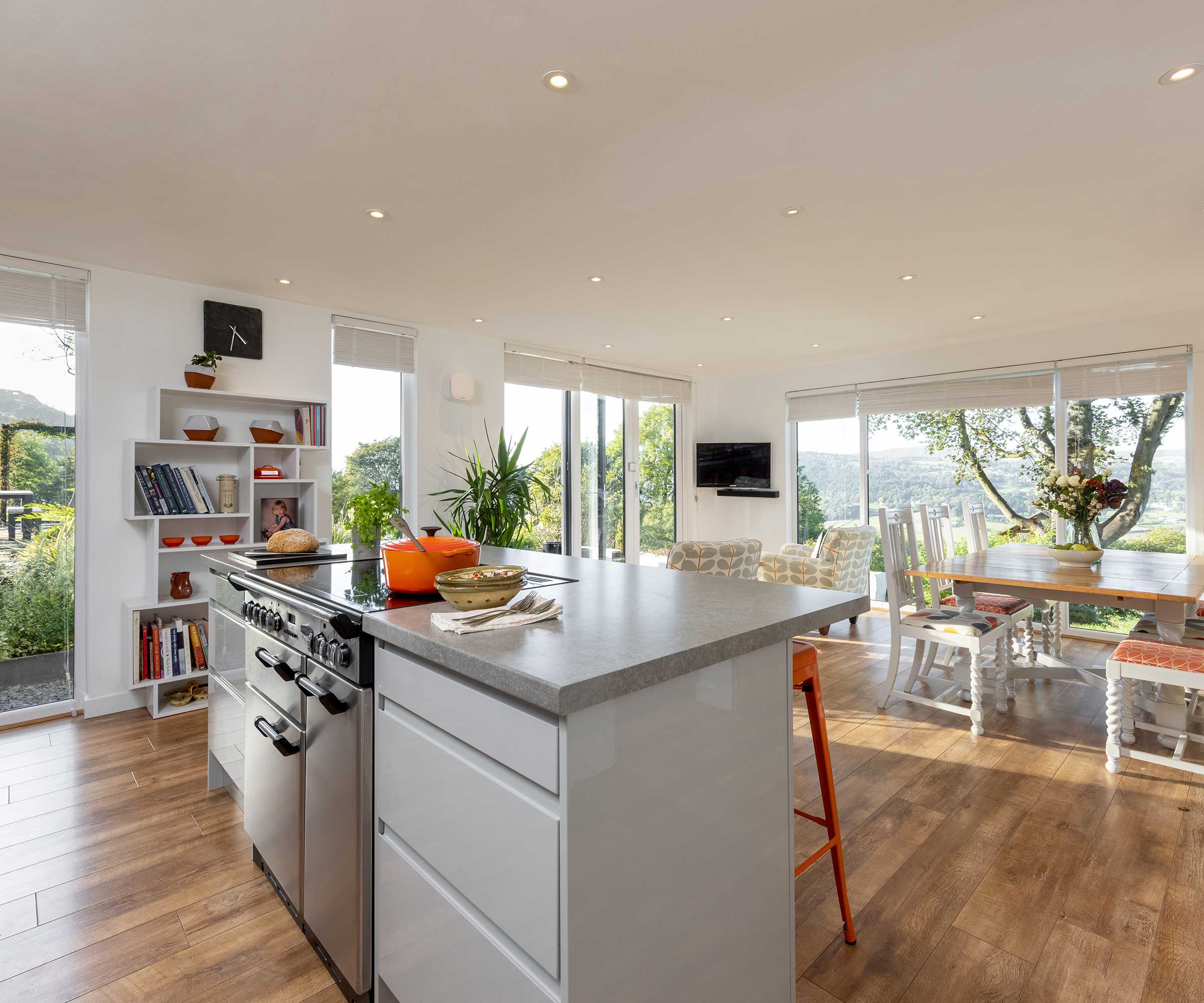 Modern kitchen extension with bifold doors, white units and grey worktops