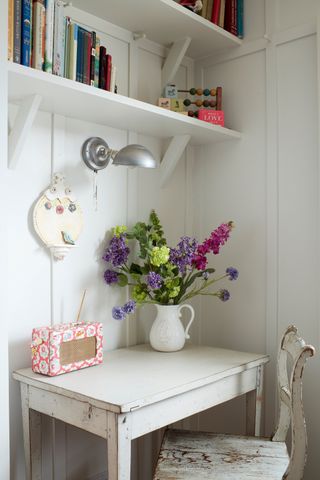 flowers and radio in panelled hallway