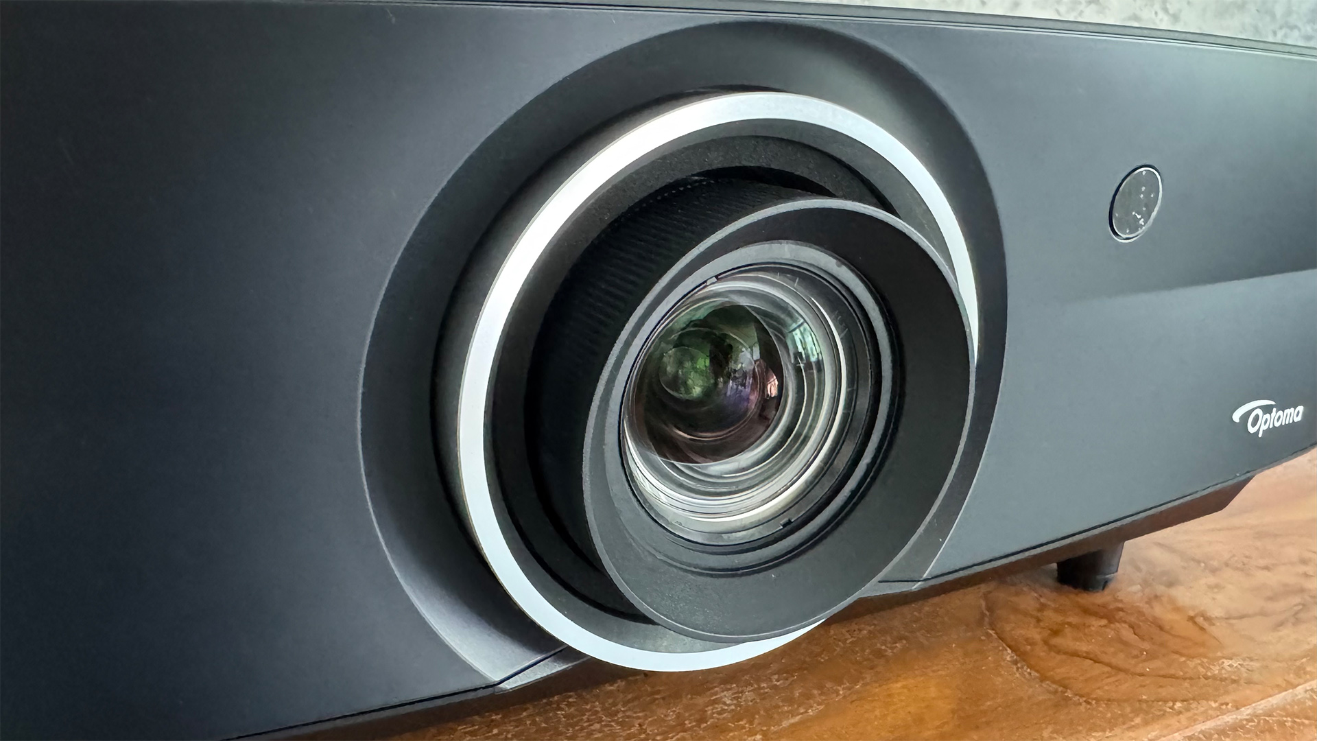 Optoma UHZ68LV home cinema projector close up on lens