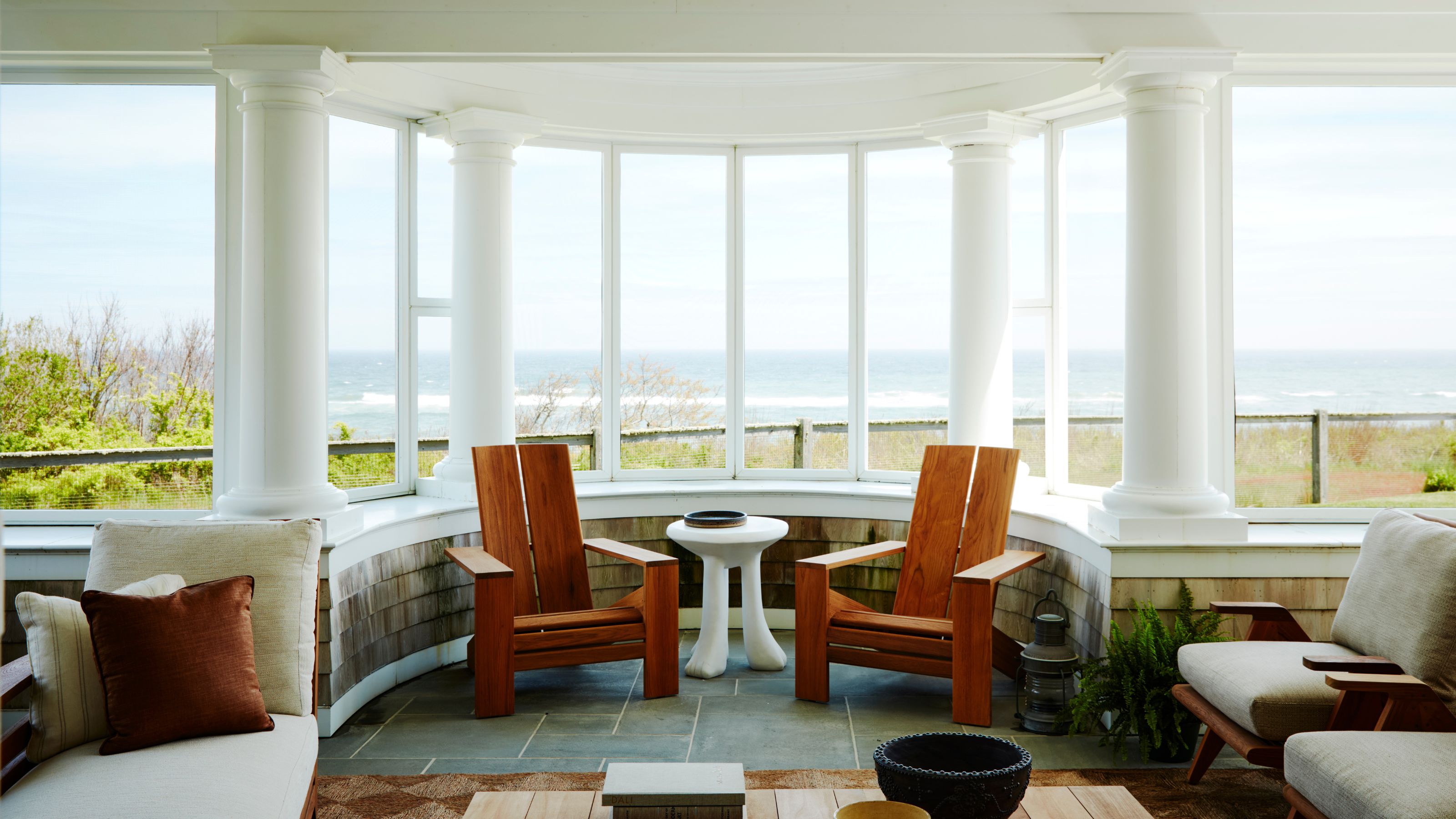 Front porch with columns, adirondack chairs and coffee table