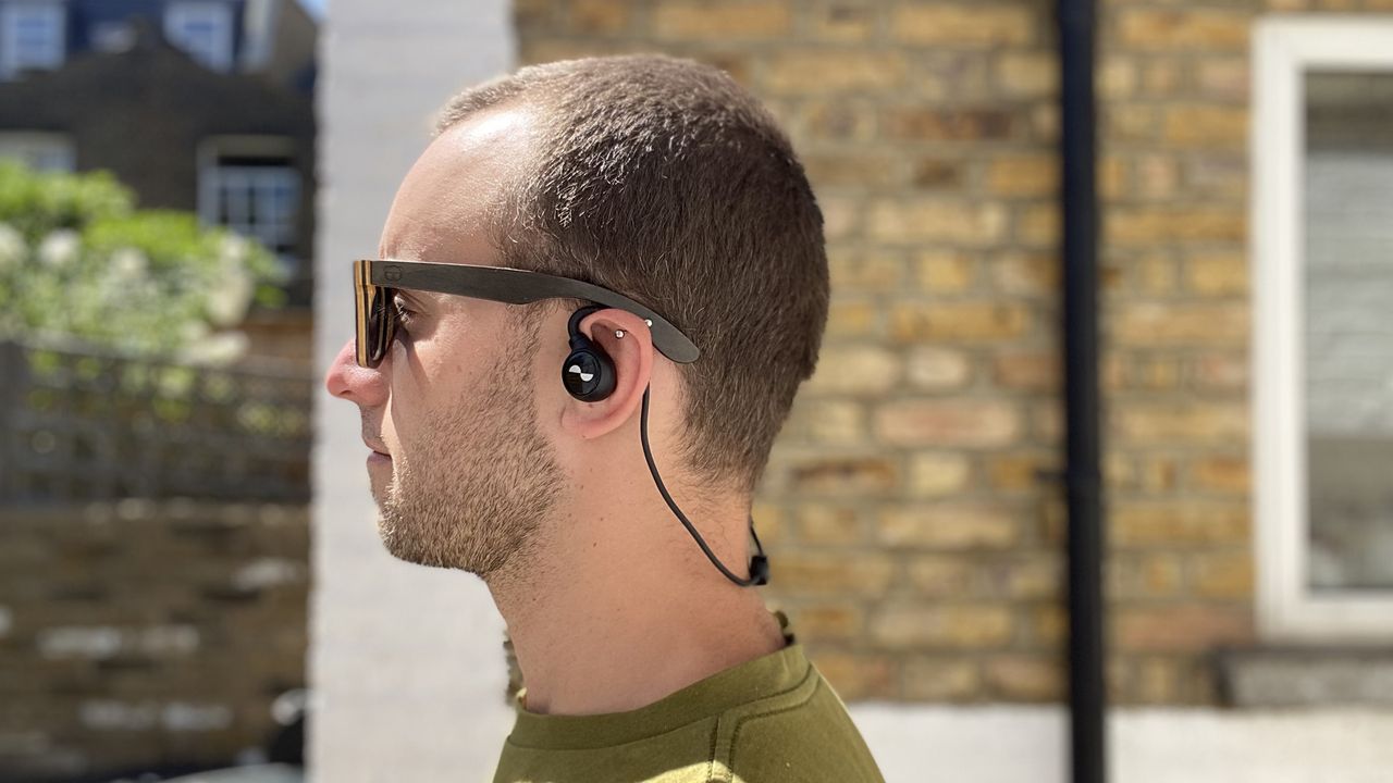 Man wearing NuraLoop workout earbuds