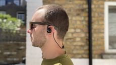 Man wearing NuraLoop workout earbuds