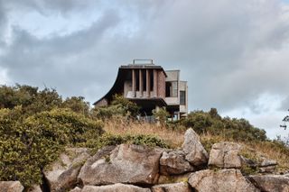 hero exterior of australian house perched on rocks