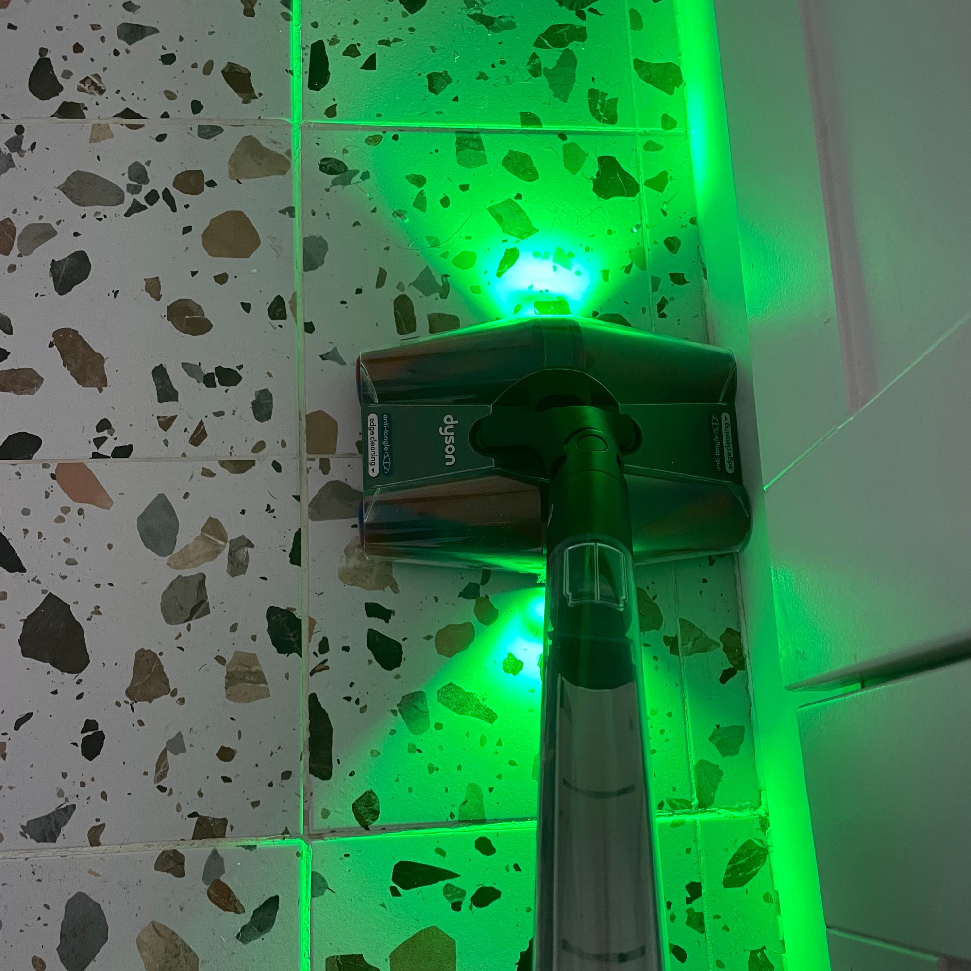 Dyson PencilVac cleaning the edges of terrazzo tiled floor