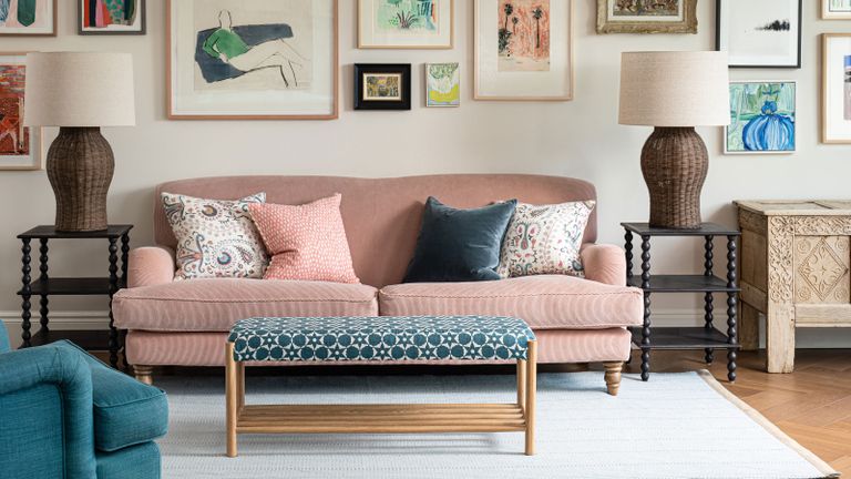 seating area with pink sofa and blue patterned footstool