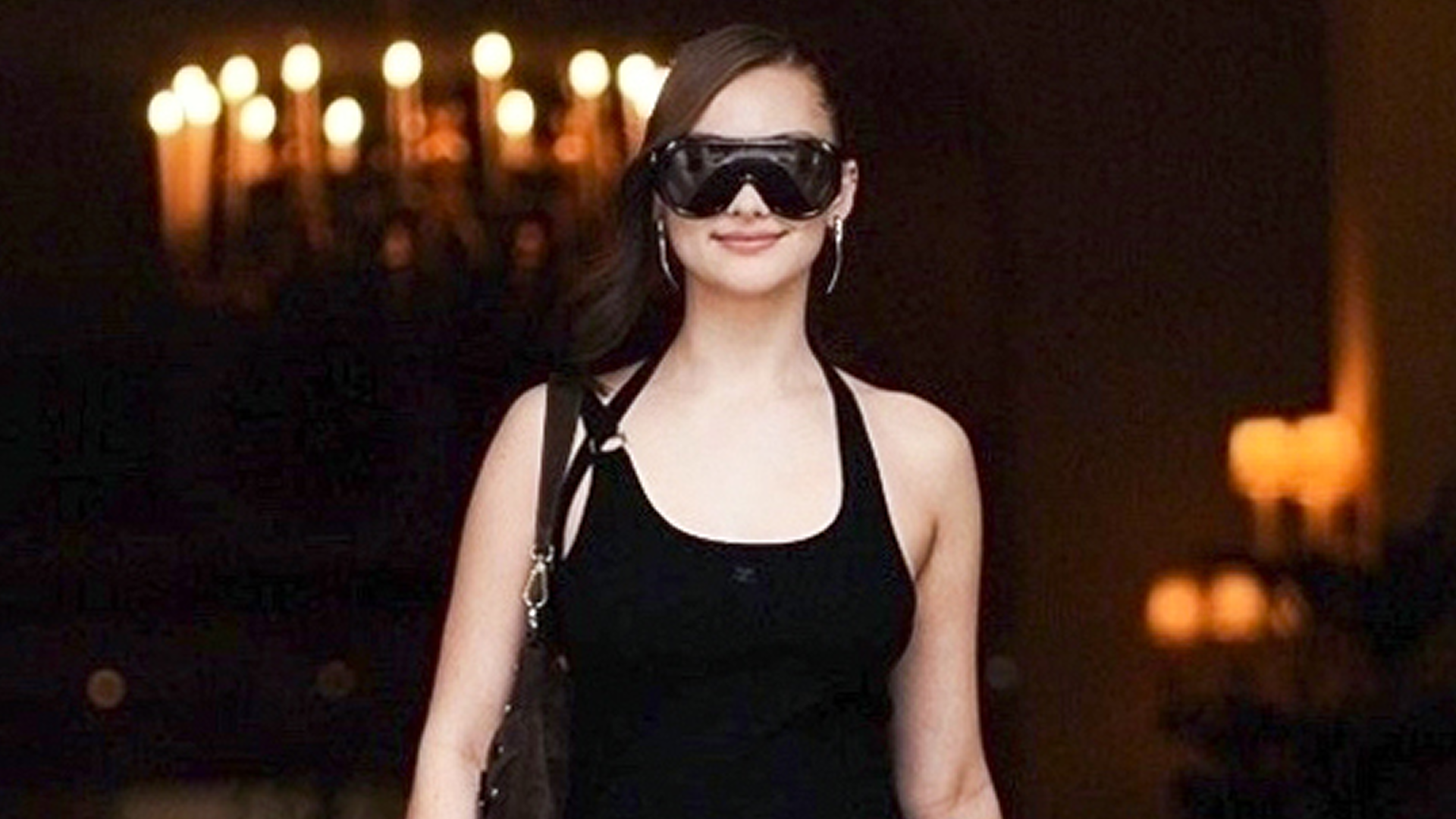 Lola Tung was spotted in Paris wearing an anti-Belly little black dress and leather legging boots