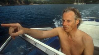 Sir George Martin driving a speeedboat near Air Studios Montseratt, West Indies, in 1979