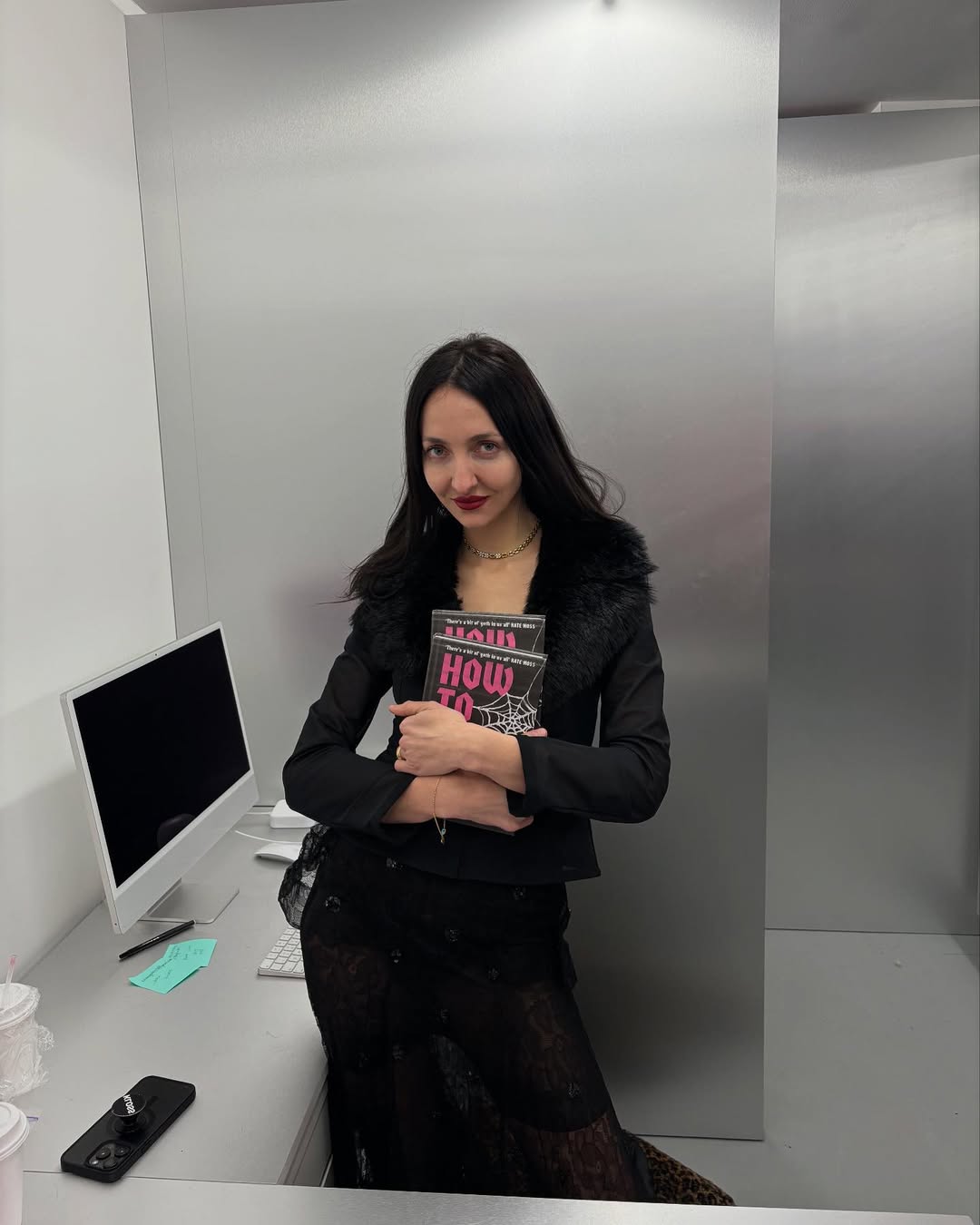 Tish Weinstock holding her book.