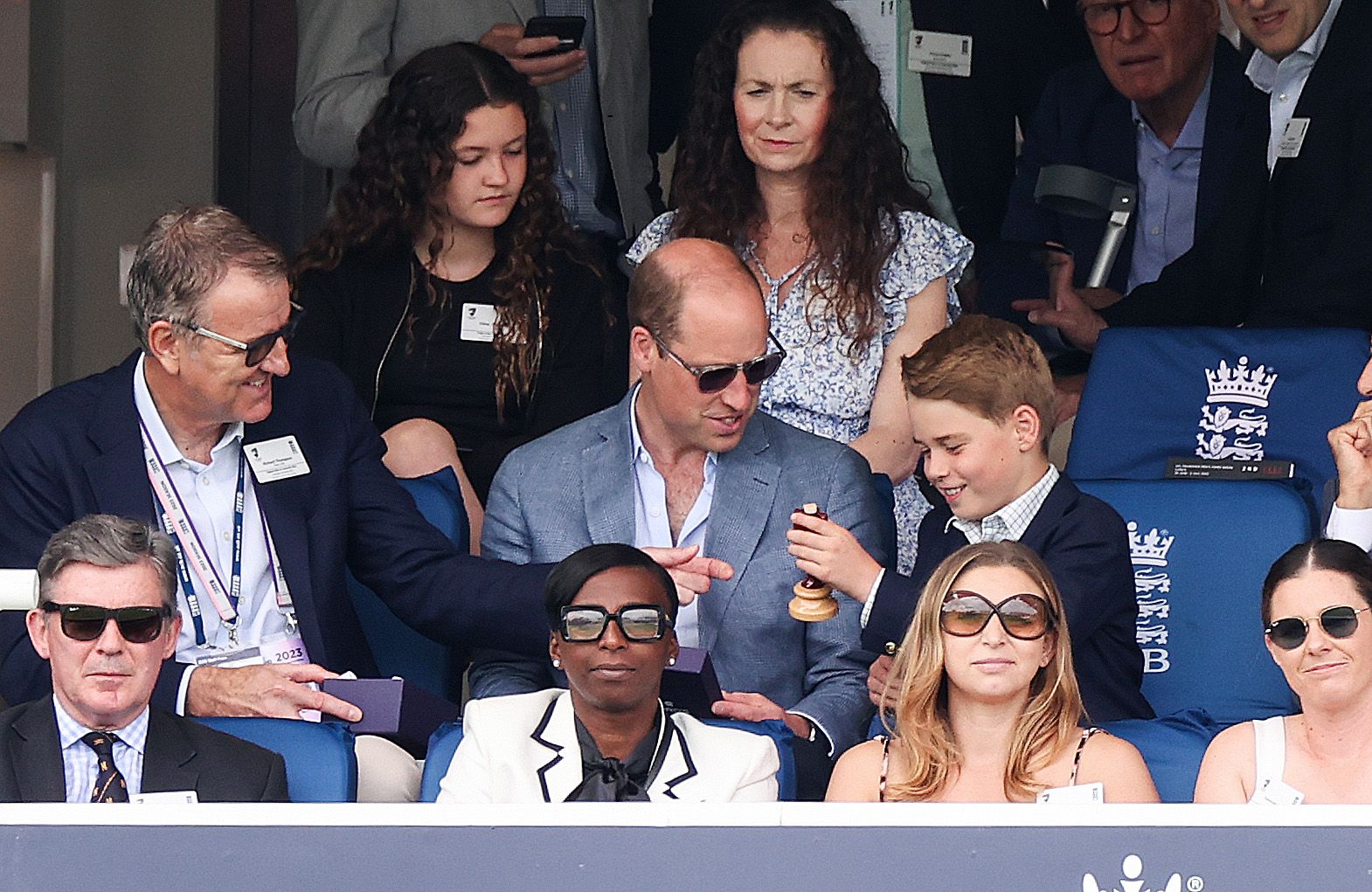 Prince William and Prince George interact at a cricket match