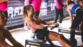 A woman on the rowing machine taking part in Level Seven