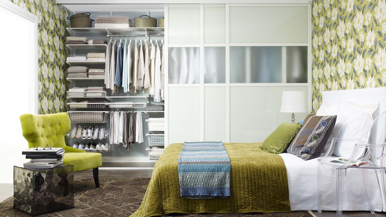 A bedroom with an open well-organised wardrobe