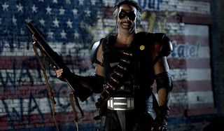 Watchmen Jeffrey Dean Morgan looking twisted with a shotgun