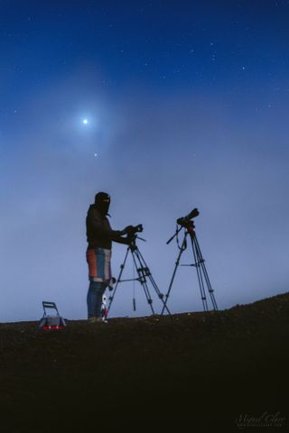 An astrophotographer stands in front of his equipment in the final stage of the total lunar eclipse on Jan. 22, 2019, while the bright planets Venus and Jupiter shine side-by-side in the twilight sky. The image was captured in Mina de São Domingos, part of the Dark Sky Alqueva Reserve in Mértola, Portugal.