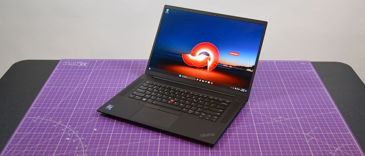 A Lenovo ThinkPad P1 Gen 6 on a table with a purple desk mat underneath