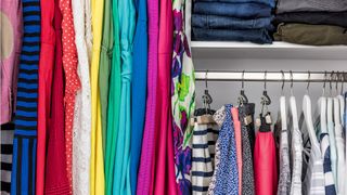 Colorful clothes in wardrobe