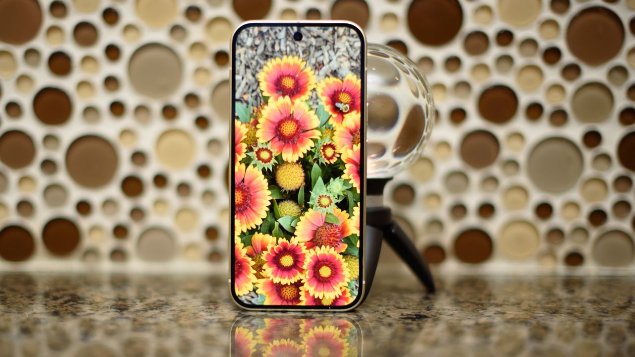 Google Pixel 10 in Lemongrass against a bubbly backsplash