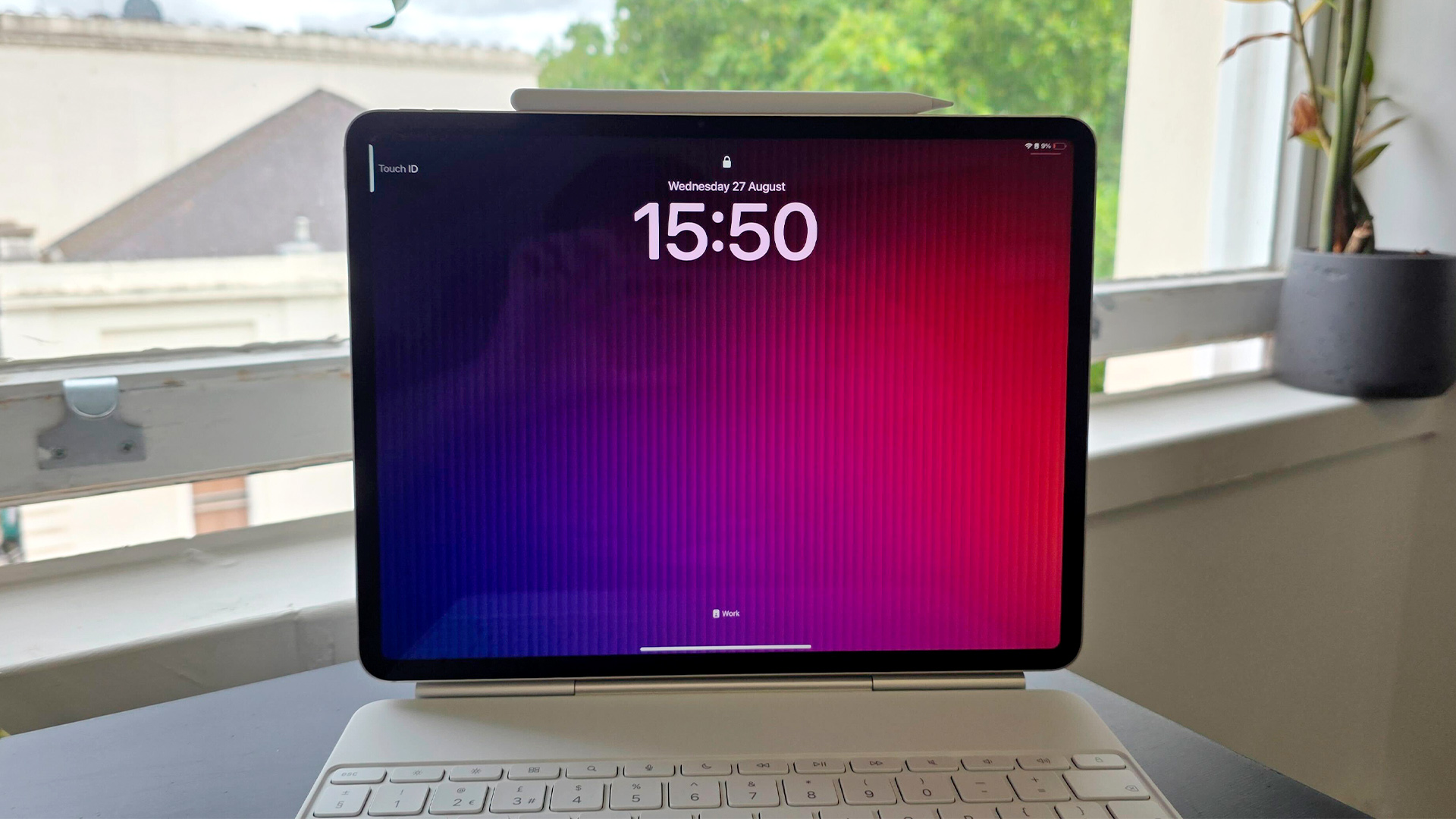 Apple iPad Air 13-inch (2025) tablet attached to keyboard showing time on screen