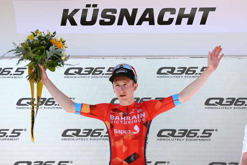 KUSNACHT SWITZERLAND JUNE 12 Stephen Williams of United Kingdom and Team Bahrain Victorious celebrates winning the stage on the podium ceremony after the 85th Tour de Suisse 2022 Stage 1 a 1776km stage from Kusnacht to Kusnacht 679m ourdesuisse2022 WorldTour on June 12 2022 in Kusnacht Switzerland Photo by Tim de WaeleGetty Images