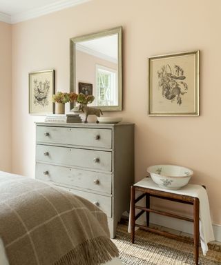 shabby chic bedroom with pale pink walls, gray dresser and mirror
