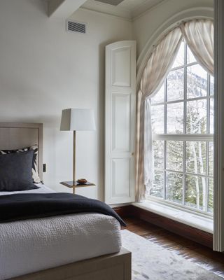 a stylish bedroom with tieback curtains