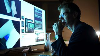 man sat at computer using development software