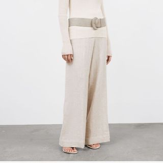 Flat lay image of woman wearing linen trousers