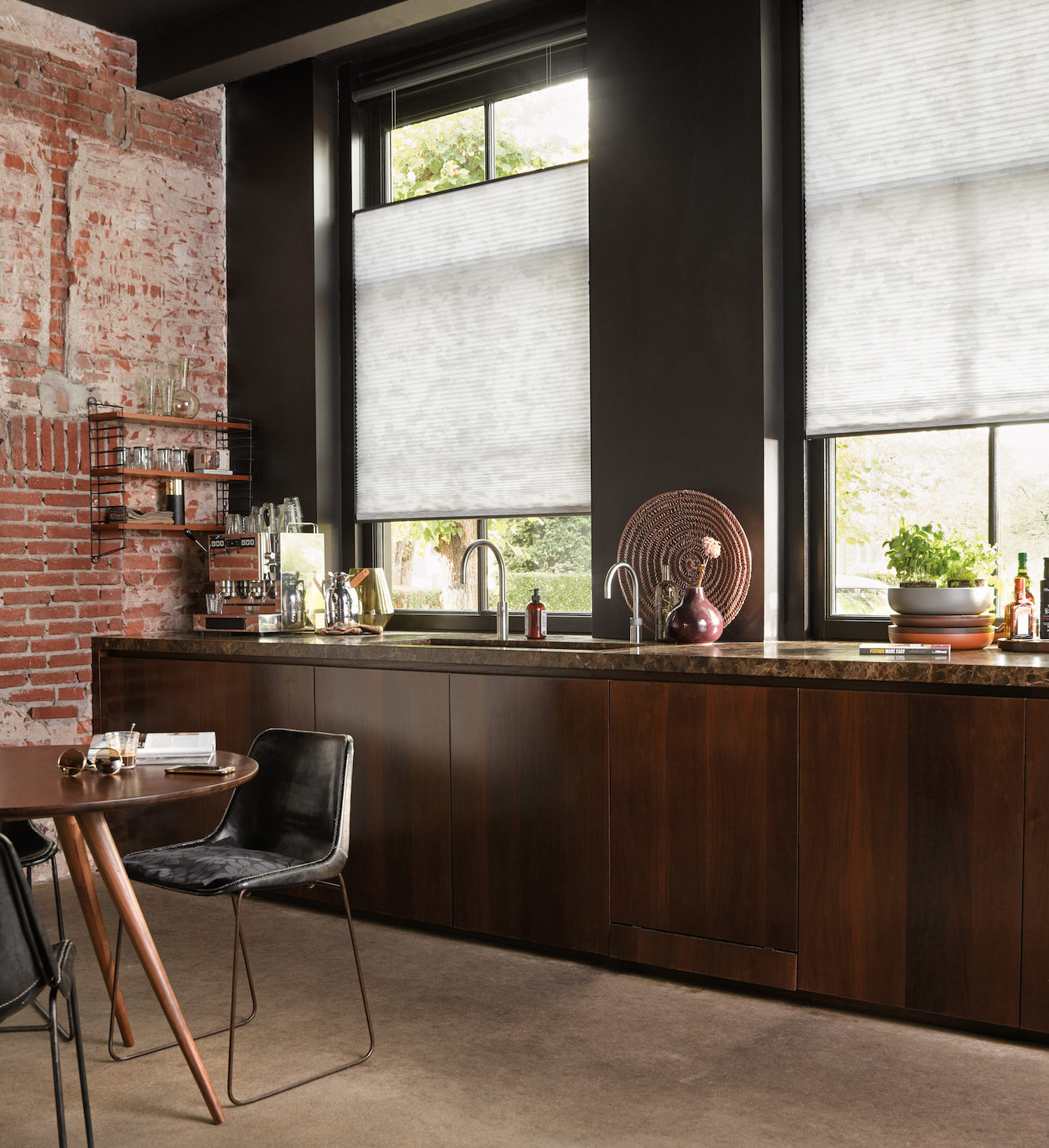 Sheer blinds in modern dark kitchen with wooden cabinets and exposed brick wall