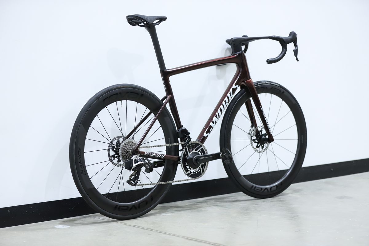 A red S-Works Tarmac SL8 stands against a white wall