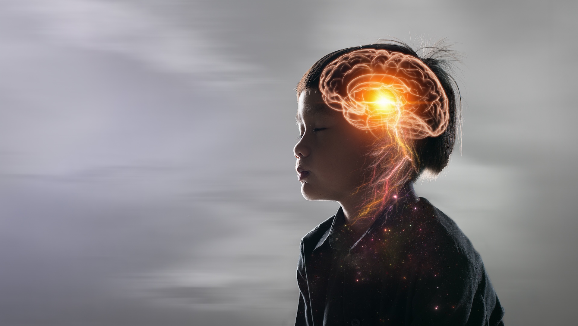 An illustration of a child with her eyes closed. A glowing illustration of a brain is on the side of her head.
