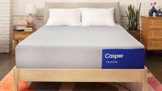 The new Casper Cloud One Mattress on a bed frame in a bedroom, two pillows places at the head of the bed