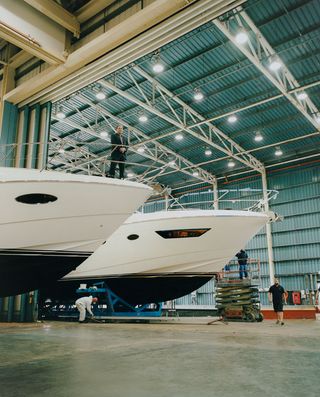 Anthony Sheriff, chairman of Princess Yachts, on the bow of one of several vessels currently under construction in their Plymouth boatyard.