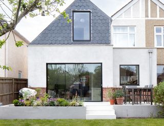 house rendering, cladding and exposed brick have been used for a decorative finish to this extension
