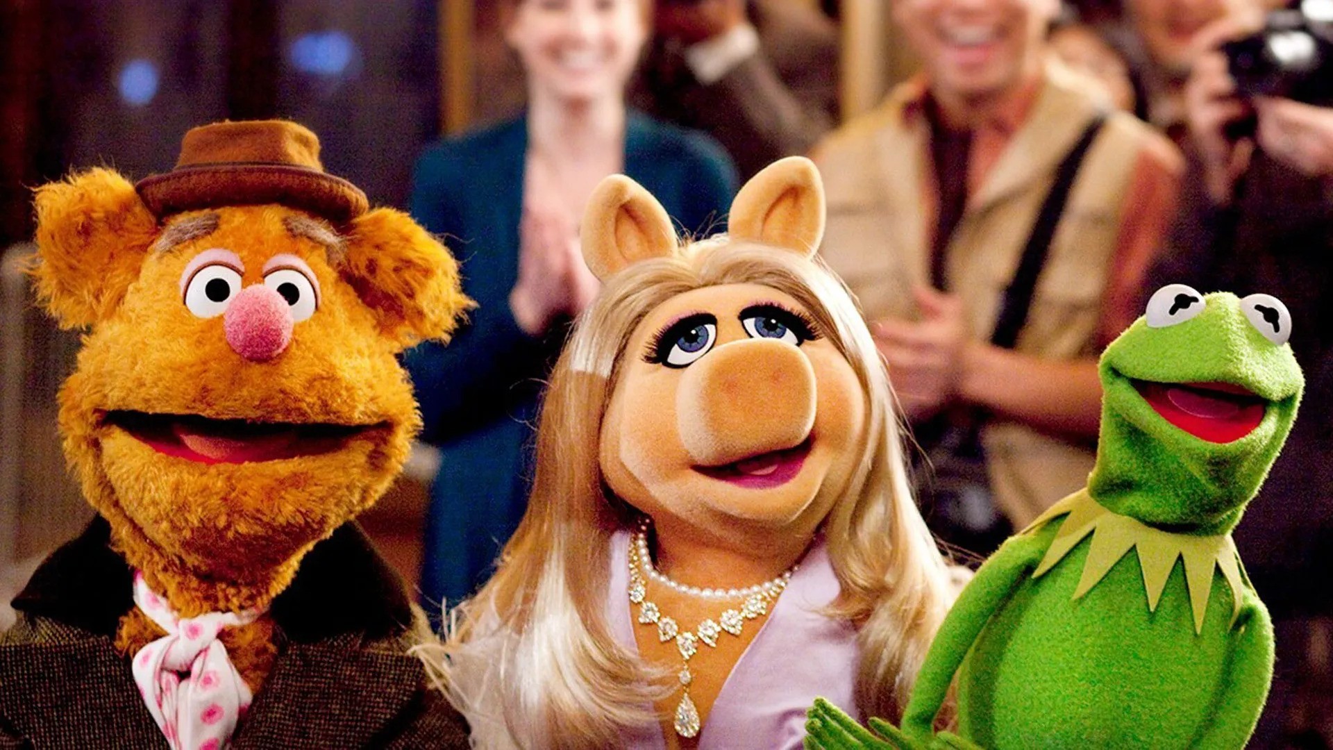 Fozzie Bear, Miss Piggy, and Kermit in a production of The Muppets
