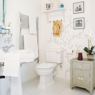 white bathroom with cupboard and washbasin