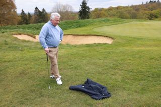 Ball resting on movable obstruction