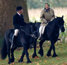 Queen Elizabeth riding a horse with her groom Terry Pendry