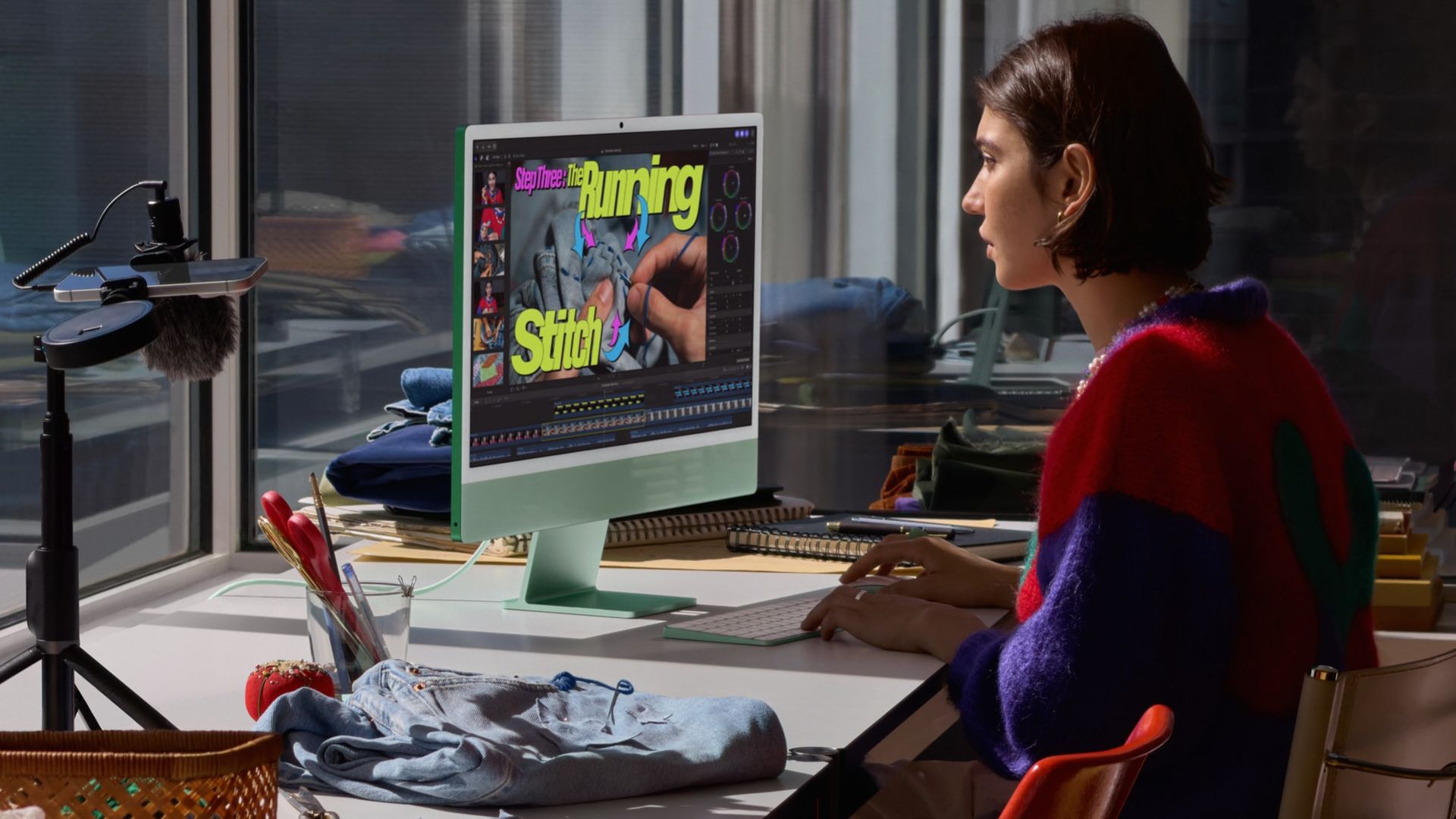 Apple iMac M6 being used by a person sat at a desk