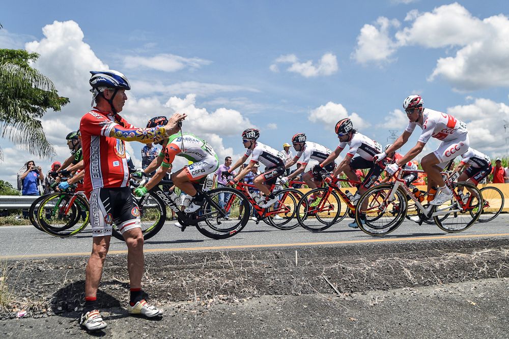 A spectator gets a photo as the peloton passes during stage 3 at Colombia Oro y Paz