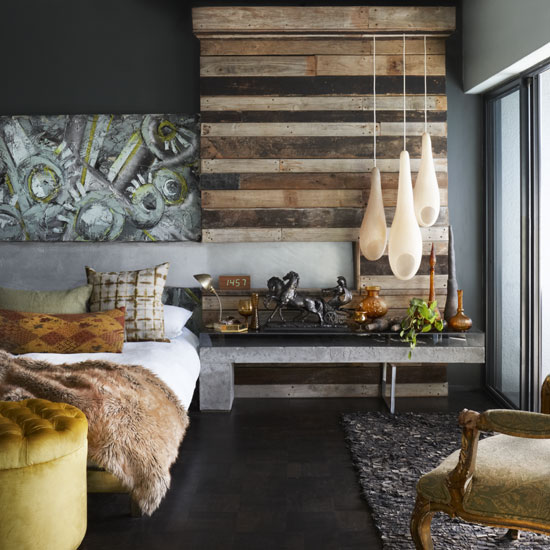 bedroom with bed chair hanging lights and wooden flooring