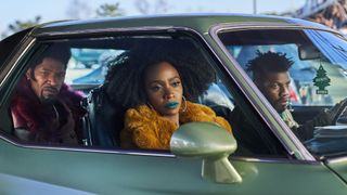Jamie Foxx, Teyonah Parris and John Boyega riding in an car as part of the They Cloned Tyrone cast