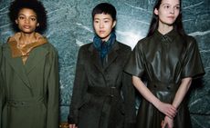 Models can be seen utilitarian outerwear, including fastened trench coats and button-up leather shirts