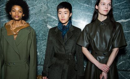 Models can be seen utilitarian outerwear, including fastened trench coats and button-up leather shirts