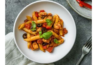 a lifestyle image showing a bowl of Jane Plan chicken arrabiata