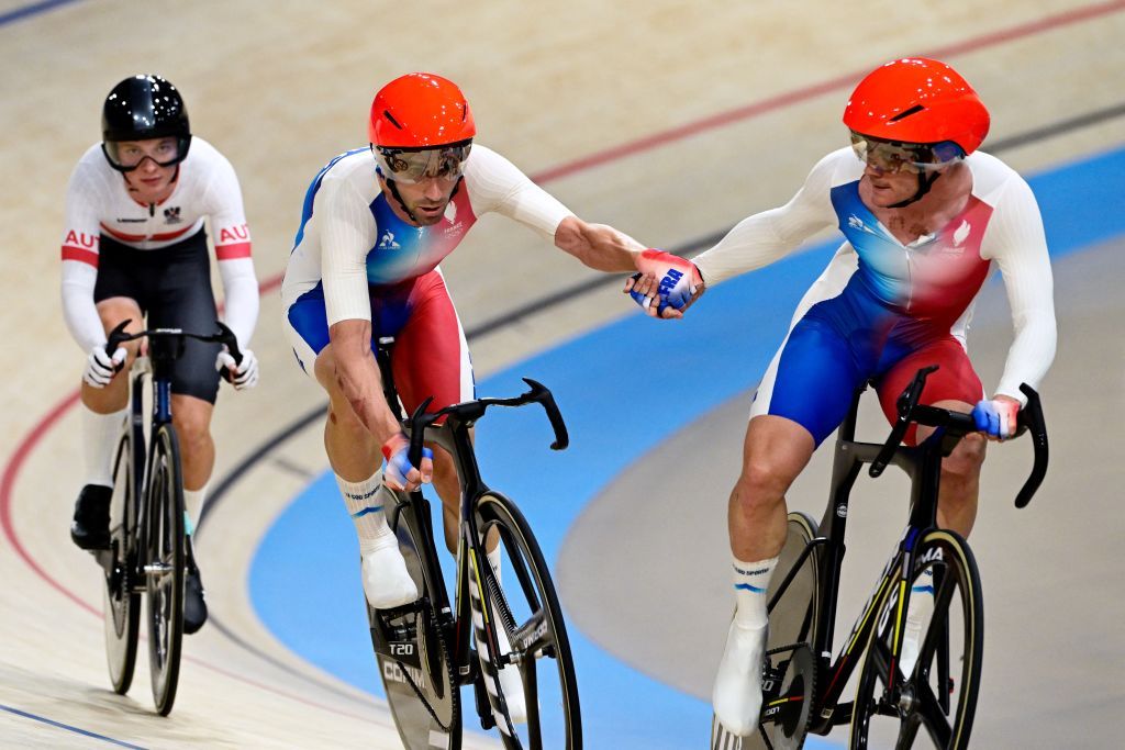 France's Benjamin Thomas relays France's Thomas Boudat as they compete in the men's track cycling madison final of the Paris 2024 Olympic Games at the Saint-Quentin-en-Yvelines National Velodrome in Montigny-le-Bretonneux, south-west of Paris, on August 10, 2024. (Photo by John MACDOUGALL / AFP)