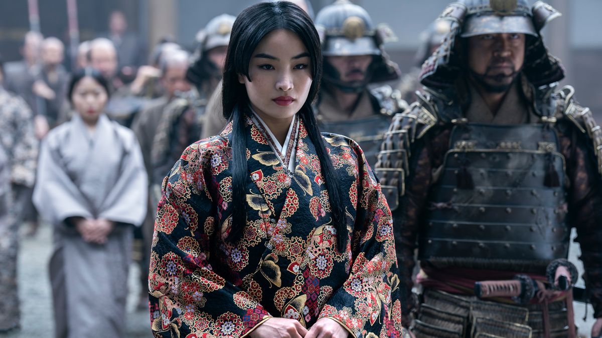 Anna Sawai stands defiantly next to an armored guard in Shōgun.