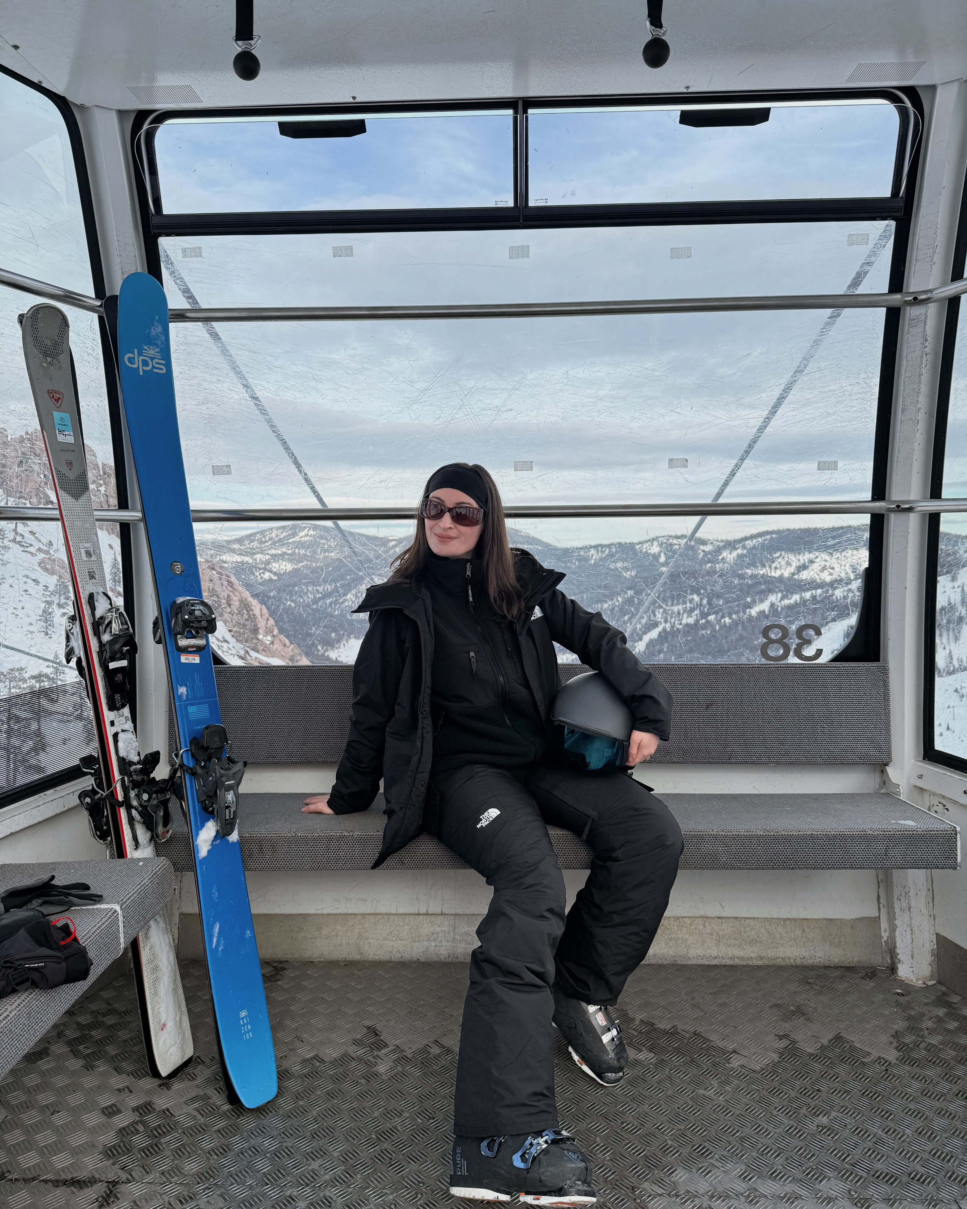 Bella Gerard wearing a ski suit in a gondola
