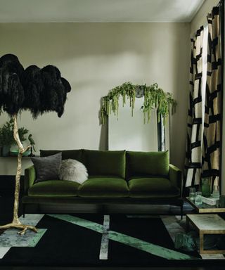 Leaf-toned velvet sofa and ostrich feather lamp in the living room.